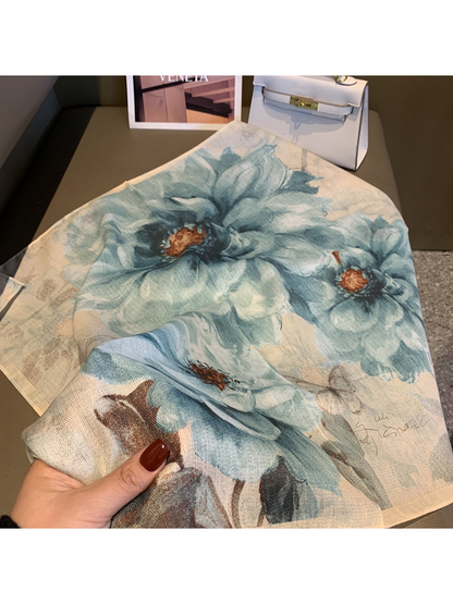 Close-up of the blue-gray floral scarf gathered to show its drape and print