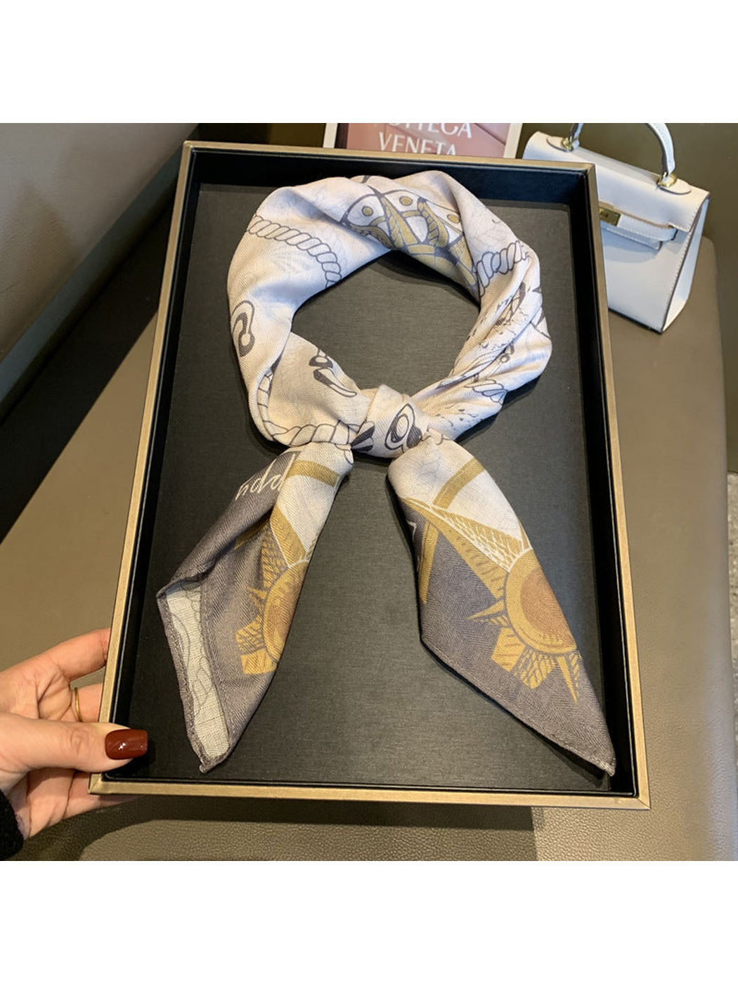 Cream and gray nautical print square scarf tied in a loop with pointed ends