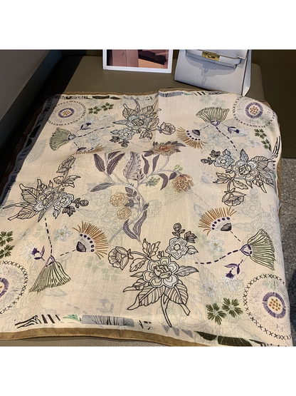 Ivory square scarf opened to show the full multicolor floral and abstract botanical pattern
