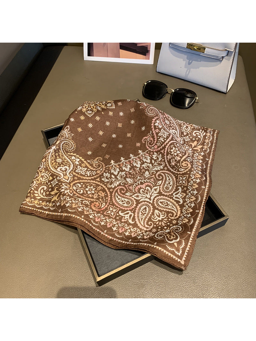 Brown square scarf with paisley border and floral details, folded view