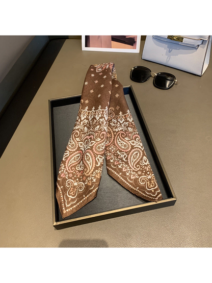 Brown paisley scarf folded lengthwise to display the patterned ends