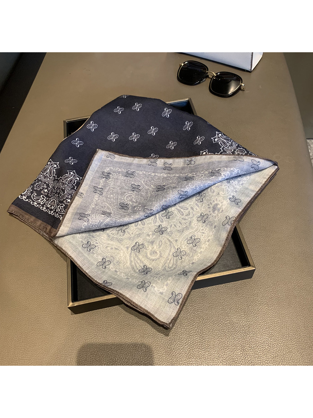 Close-up of the scarf folded back to reveal the paler reverse print