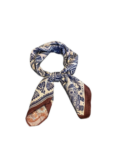 Navy, beige and brown elephant-pattern scarf tied in a loose knot