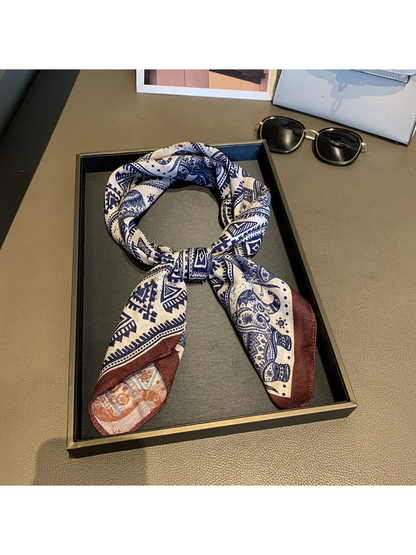 Navy, beige and brown elephant-pattern scarf styled in a loose knot