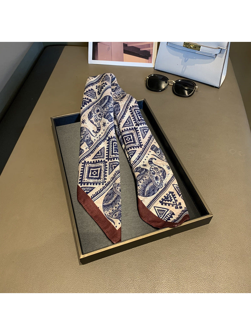 Elephant-pattern scarf arranged lengthwise with contrasting brown tips