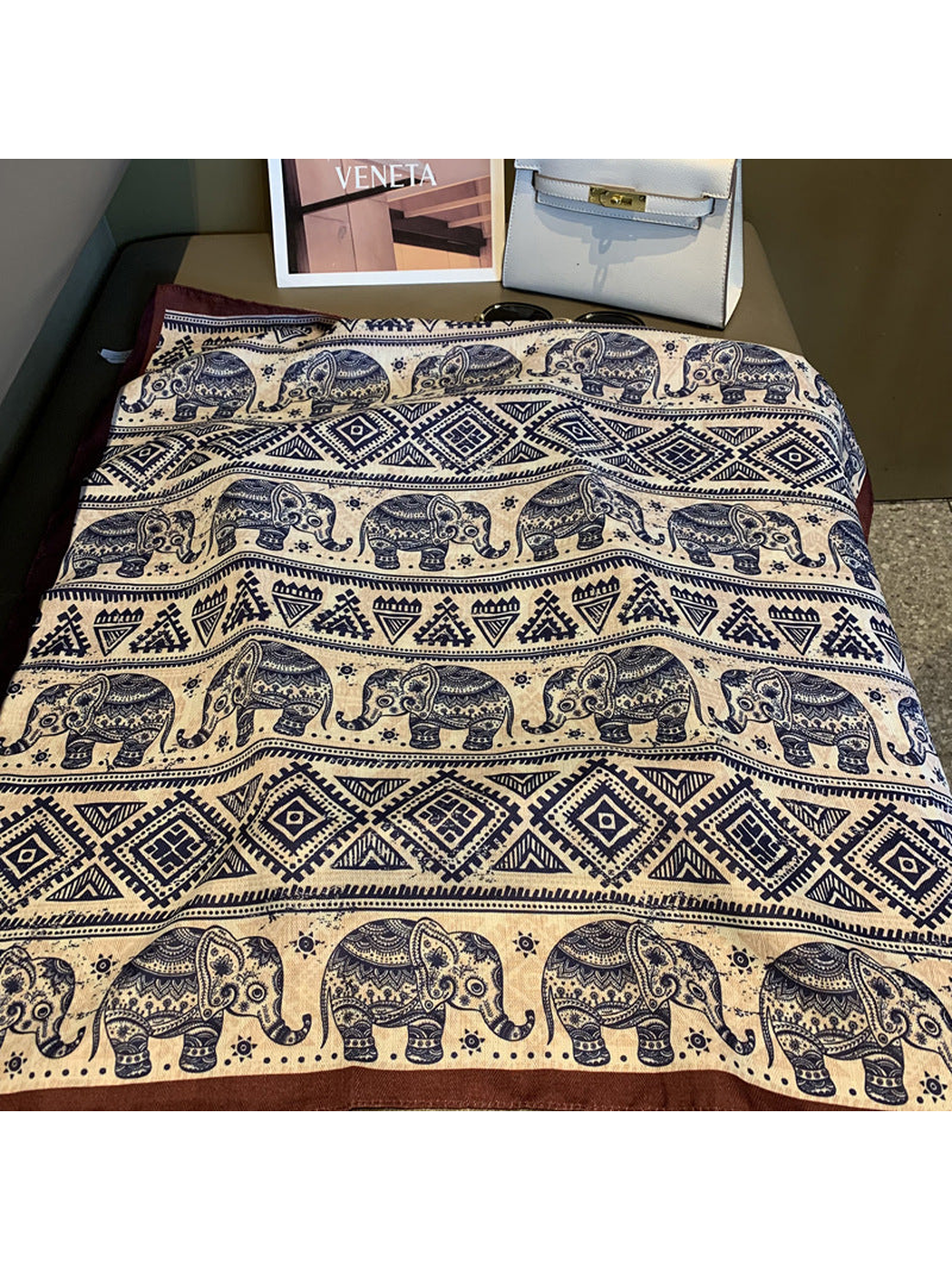 Close-up of navy elephant, diamond and triangle pattern bands with brown border