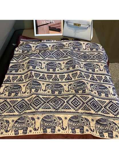 Close-up of navy elephant, diamond and triangle pattern bands with brown border