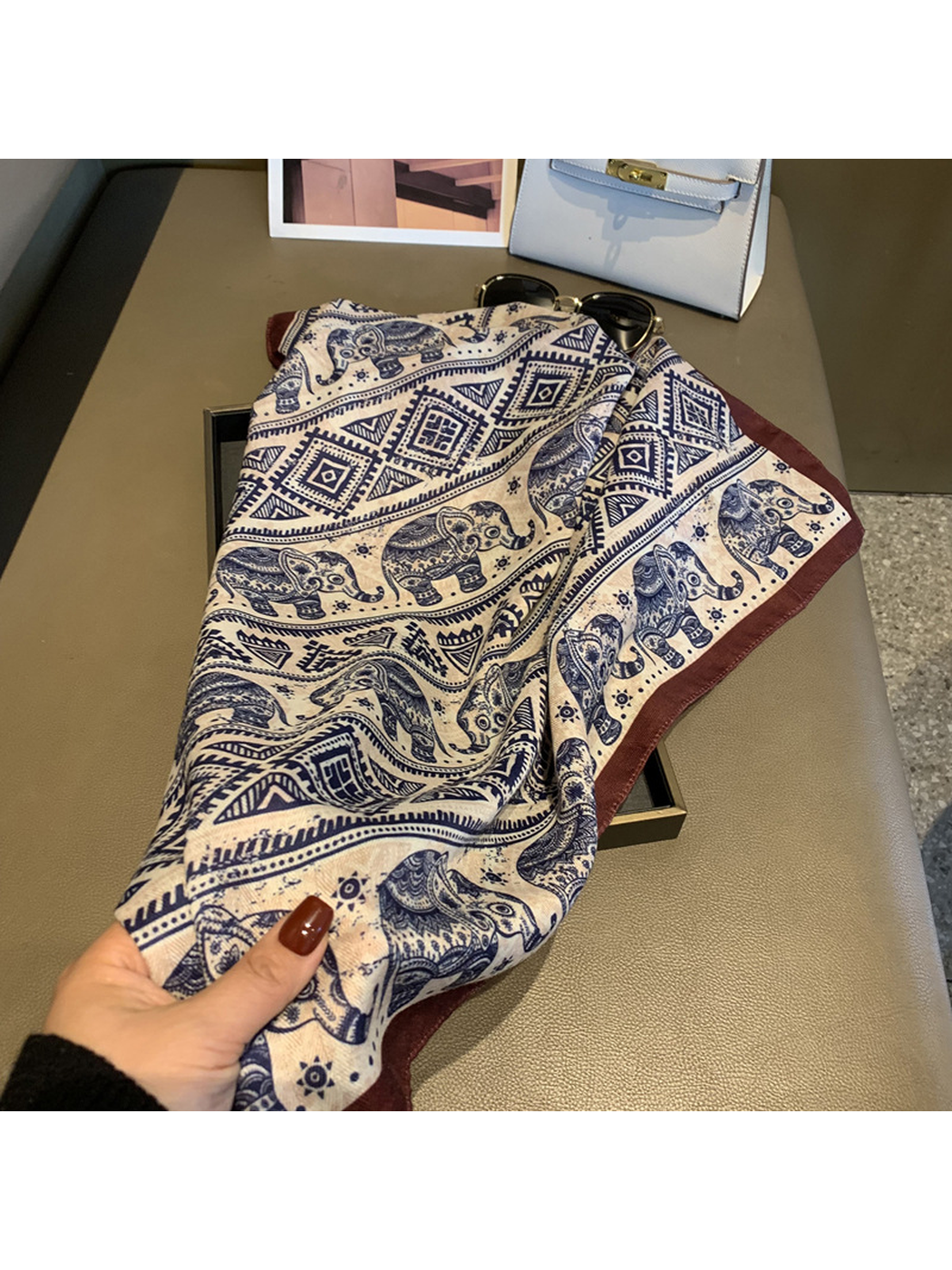 Close-up of the scarf drape, elephant motifs and contrasting brown edge