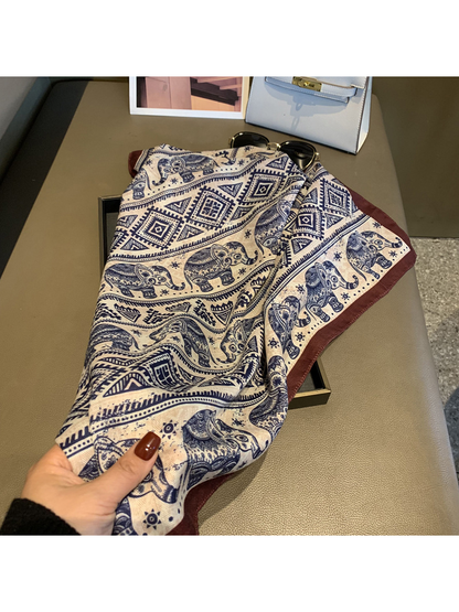 Close-up of the scarf drape, elephant motifs and contrasting brown edge