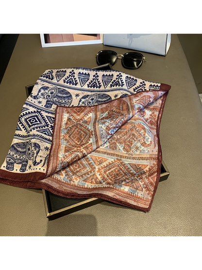 Close-up of the navy elephant-pattern front and rust-brown patterned reverse