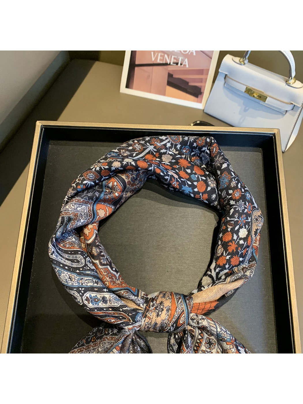 Close-up of the scarf's floral print and fine woven-look texture