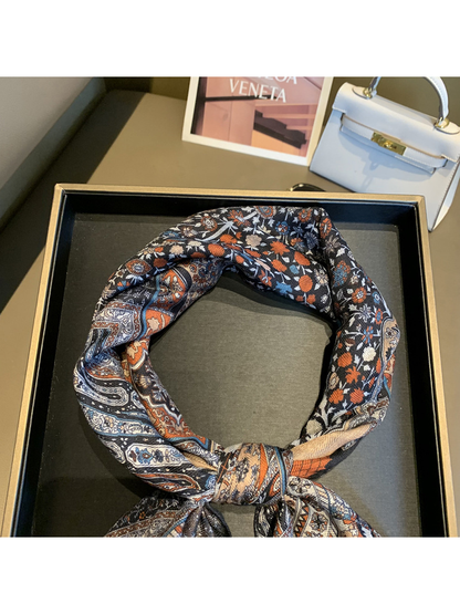 Close-up of the scarf's floral print and fine woven-look texture