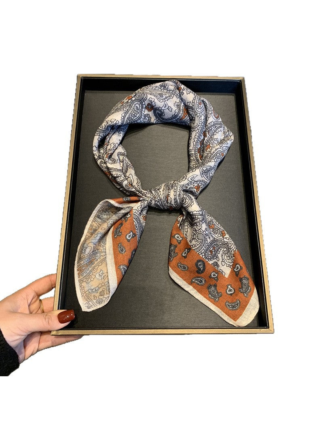 Cream paisley square scarf with rust-orange border, tied display