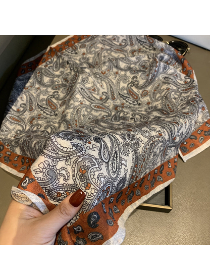 Close-up of the paisley pattern, woven-look texture and rust-orange border