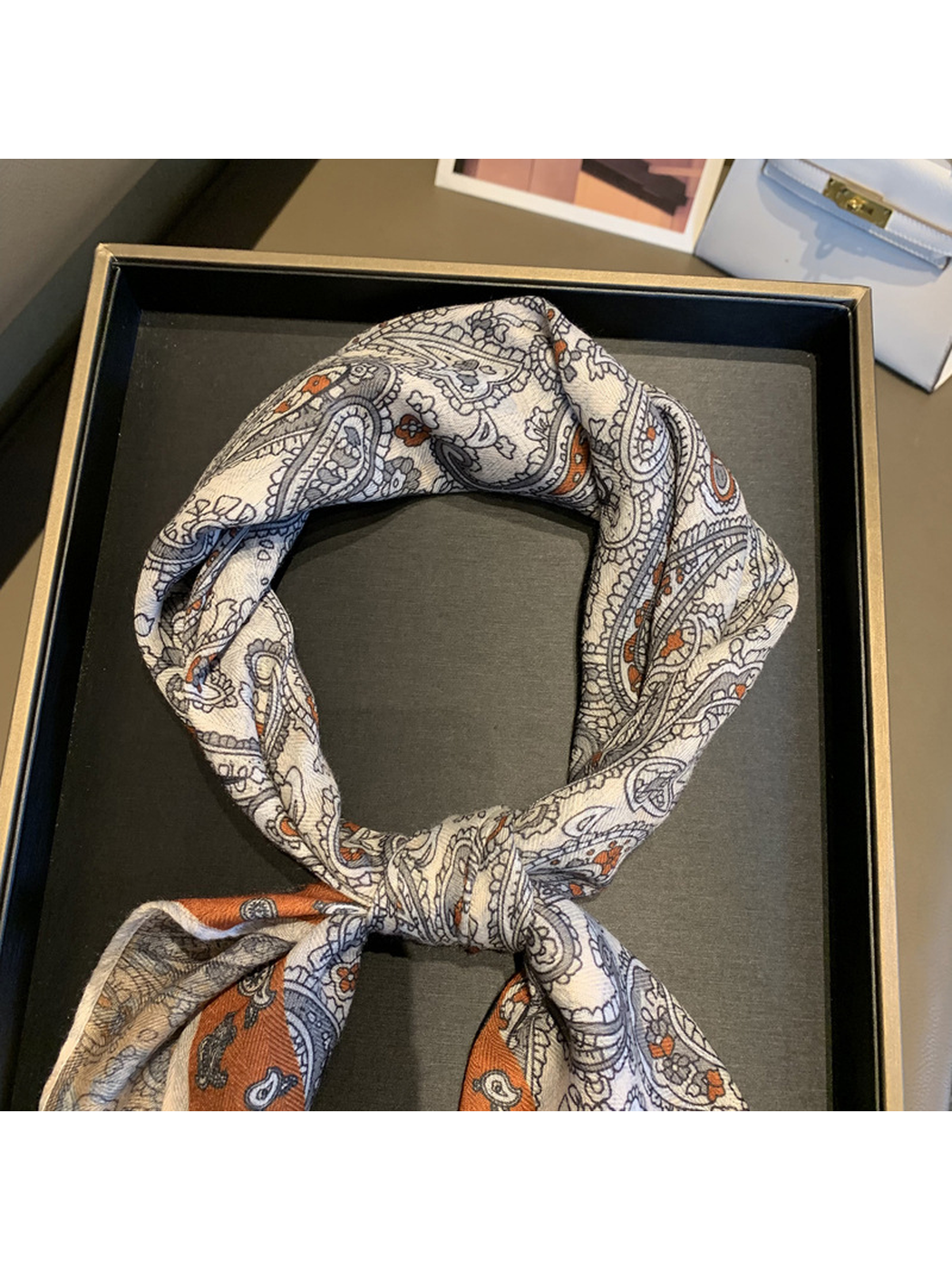 Close-up of the scarf knot and fine paisley pattern