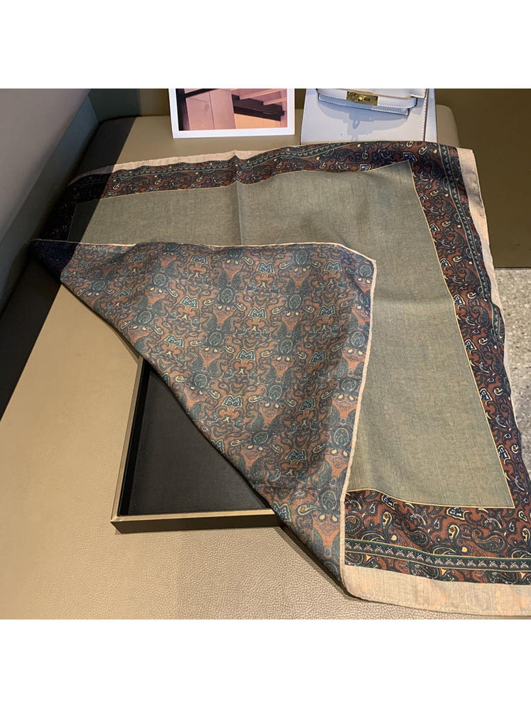 Scarf folded back to reveal the gray face and all-over paisley reverse