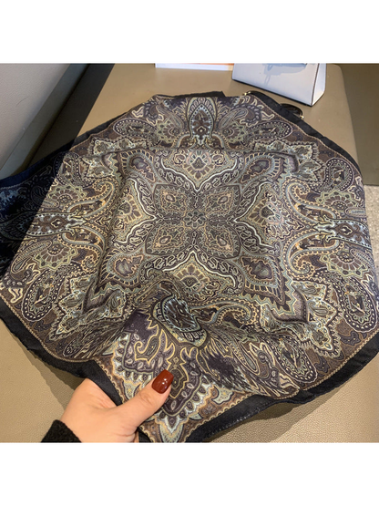 Close-up of the scarf's symmetrical paisley medallion and dark border