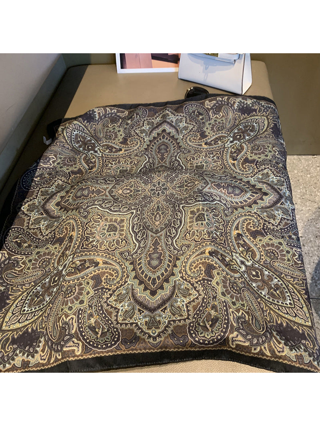 Close-up of the scarf's ornate paisley pattern and dark edge