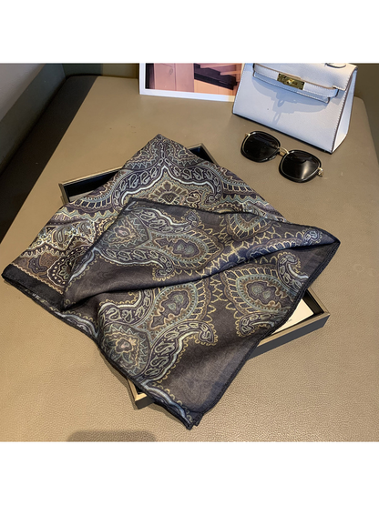 Folded scarf revealing the reverse paisley pattern in muted tones