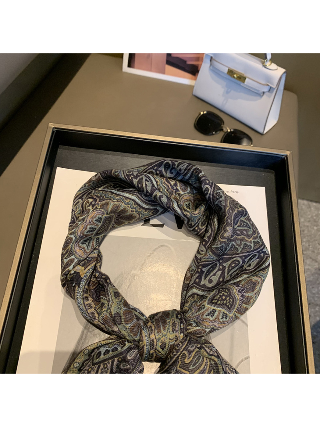 Close-up of the paisley scarf's tied loop and center knot