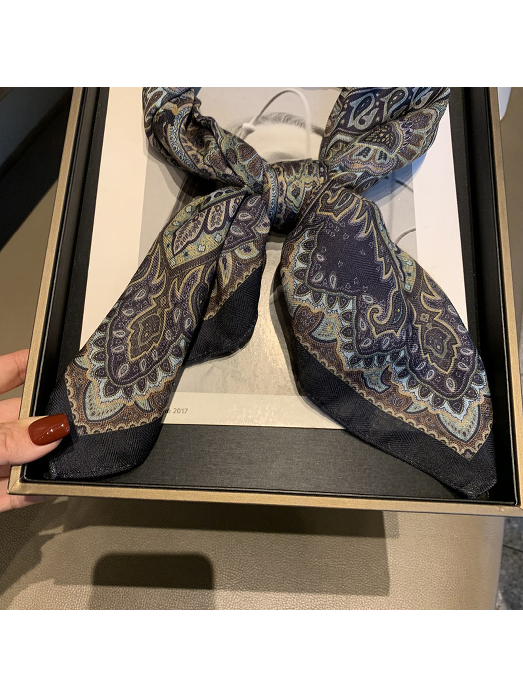 Close-up of the scarf knot, patterned ends and dark border
