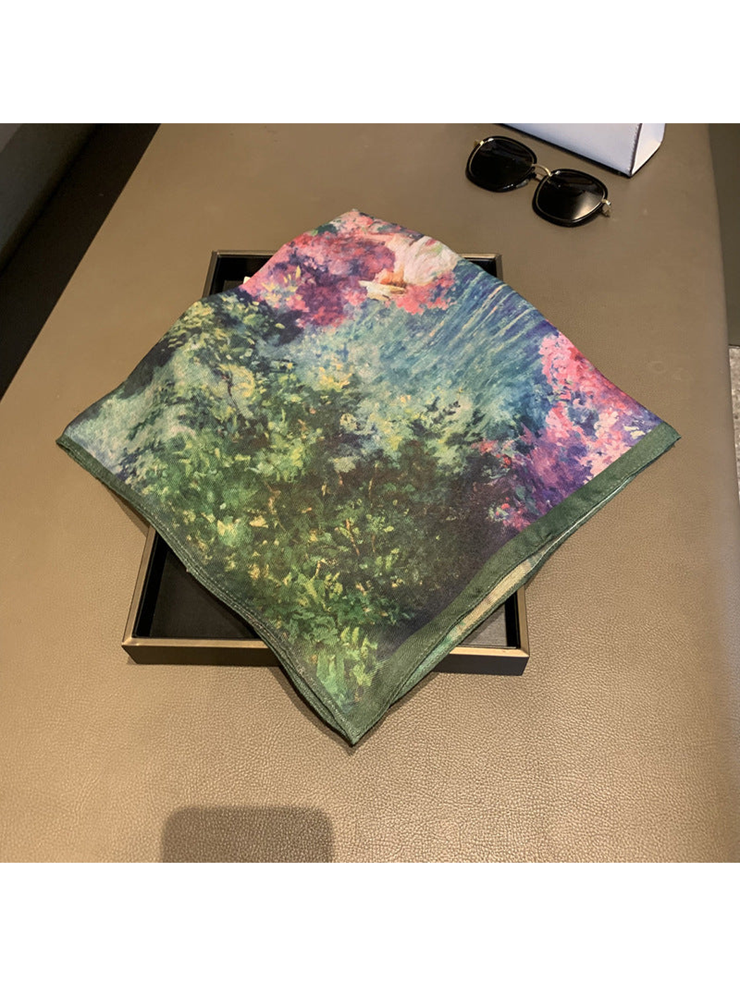 Folded multicolor square scarf showing the deep green and pink printed areas