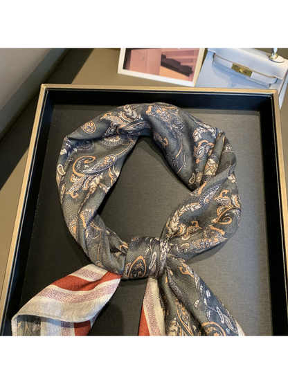 Close-up of the dark gray paisley pattern arranged in a scarf knot