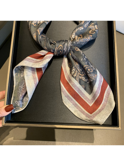 Close-up of the scarf knot, finished edge and rust-red striped border