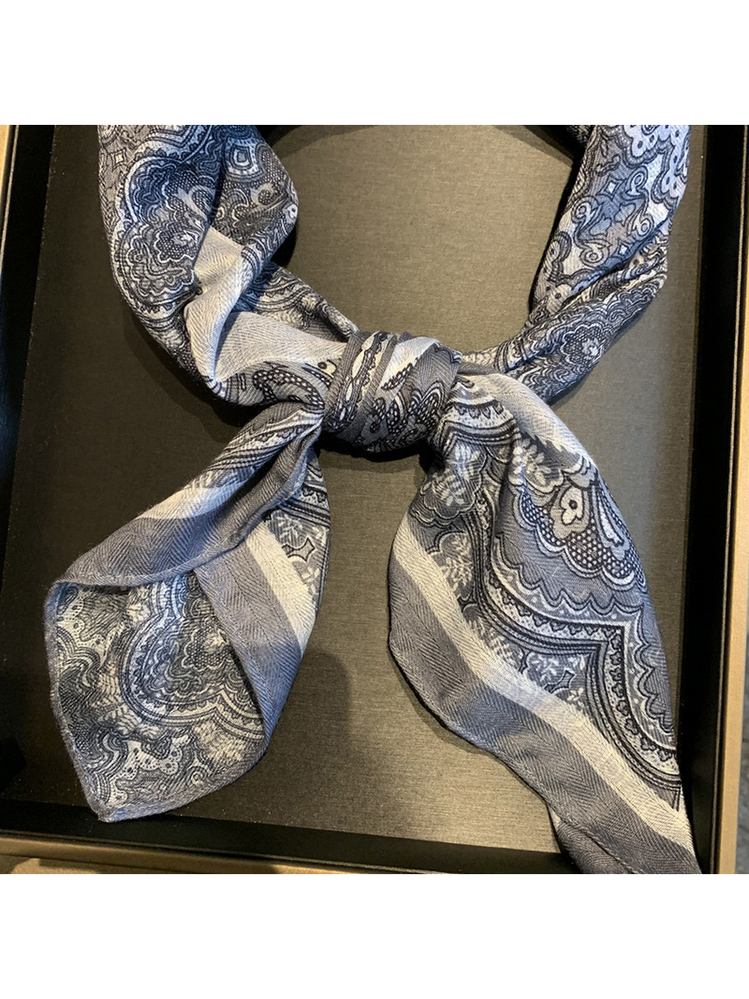 Close-up of the tied scarf ends and contrasting paisley borders
