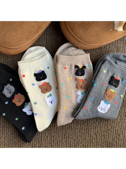 White, oatmeal, gray and black socks with colorful dots and raised animal faces