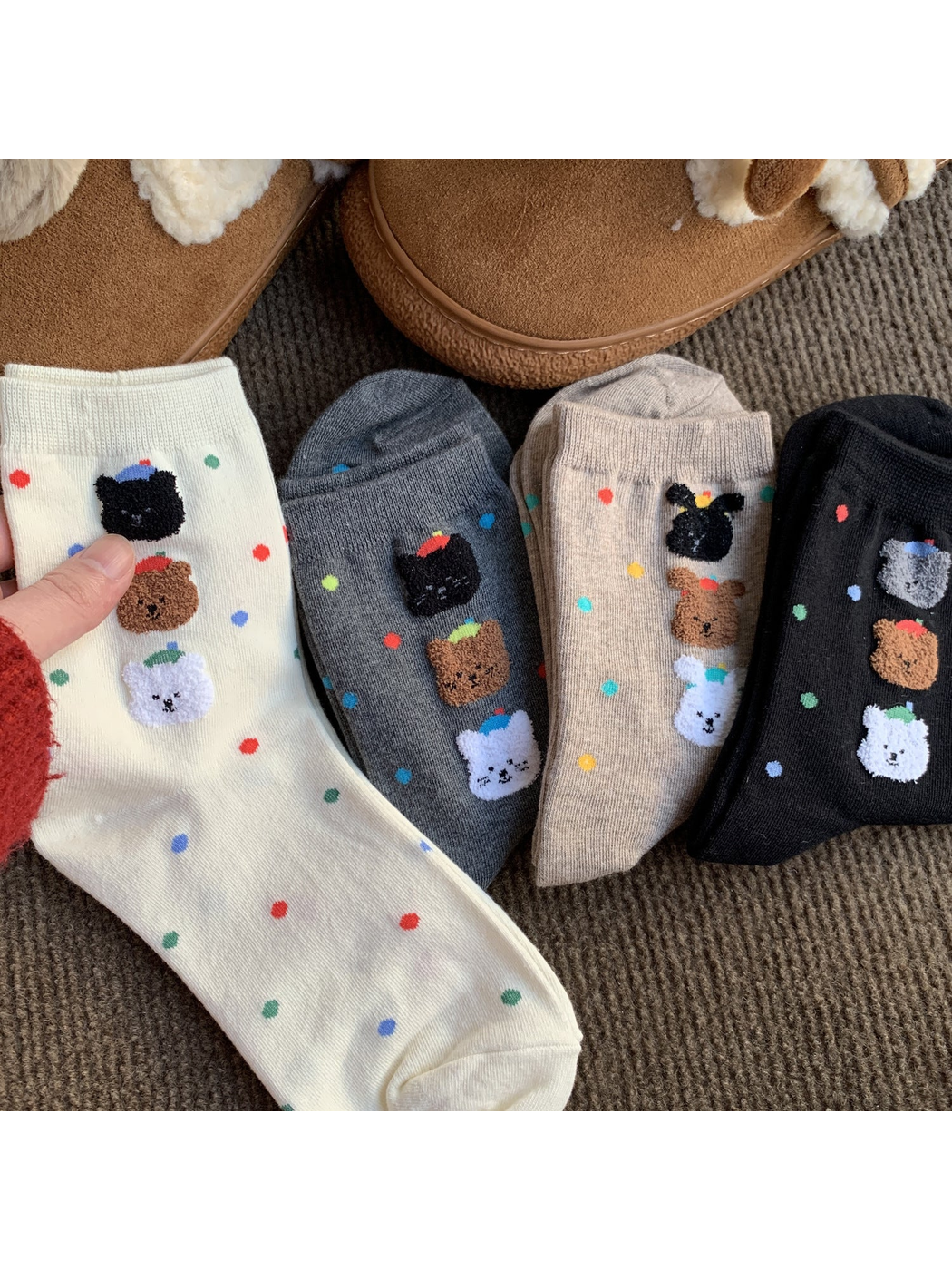 White, gray, oatmeal and black animal-face socks arranged together