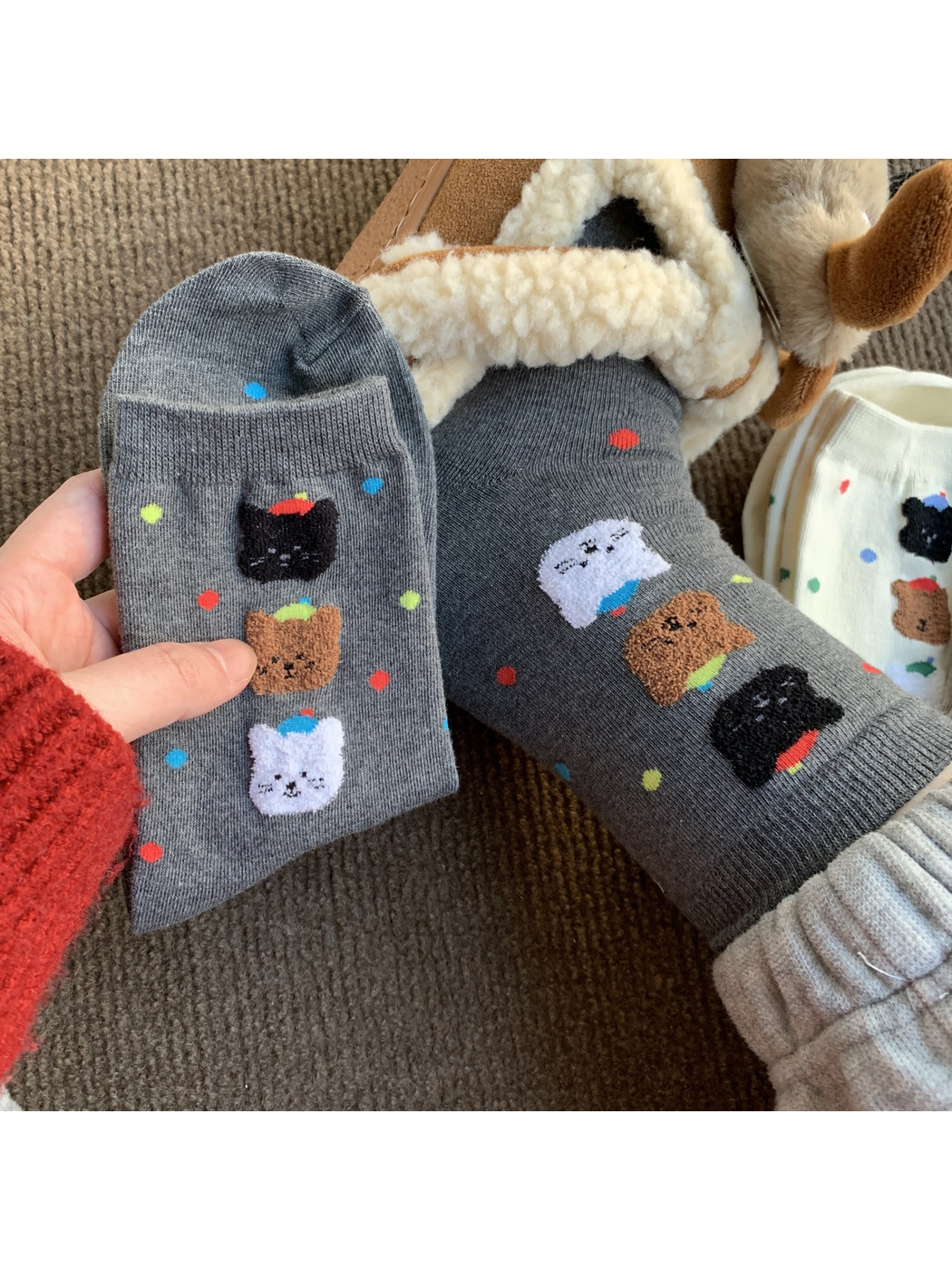 Gray crew socks with colorful dots and raised animal faces