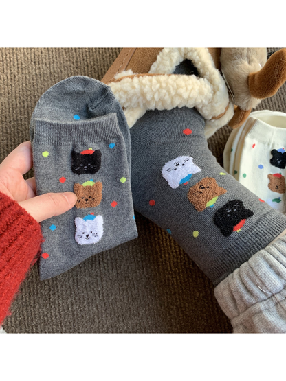 Gray crew socks with colorful dots and raised animal faces