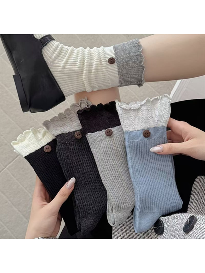 White, light gray, blue, black and dark gray ribbed socks displayed together