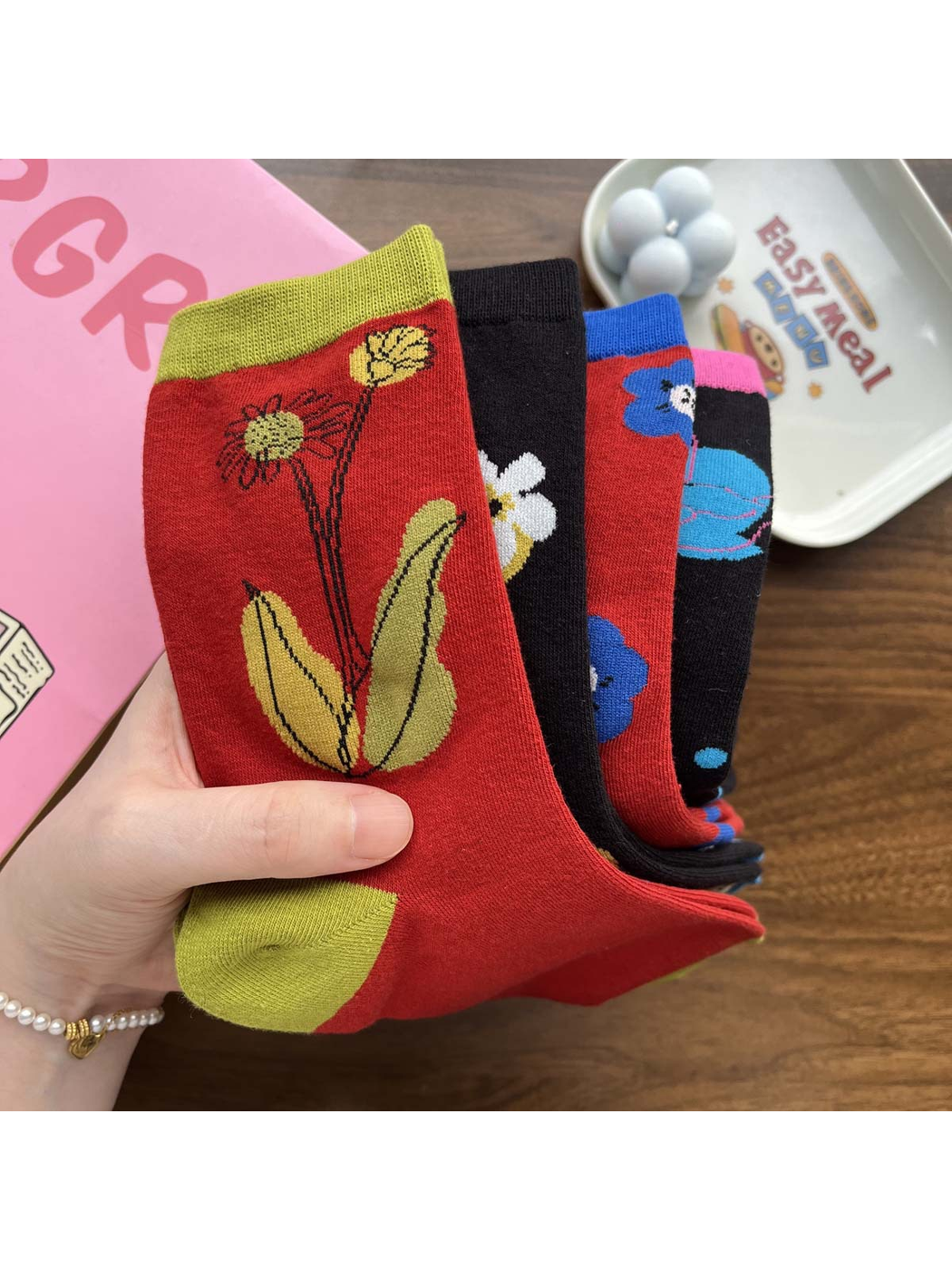 Close-up of floral crew sock patterns, knit texture and contrasting cuffs
