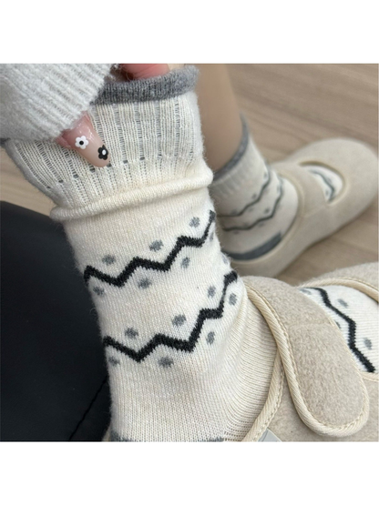 Cream crew sock with black zigzag bands and gray dot accents