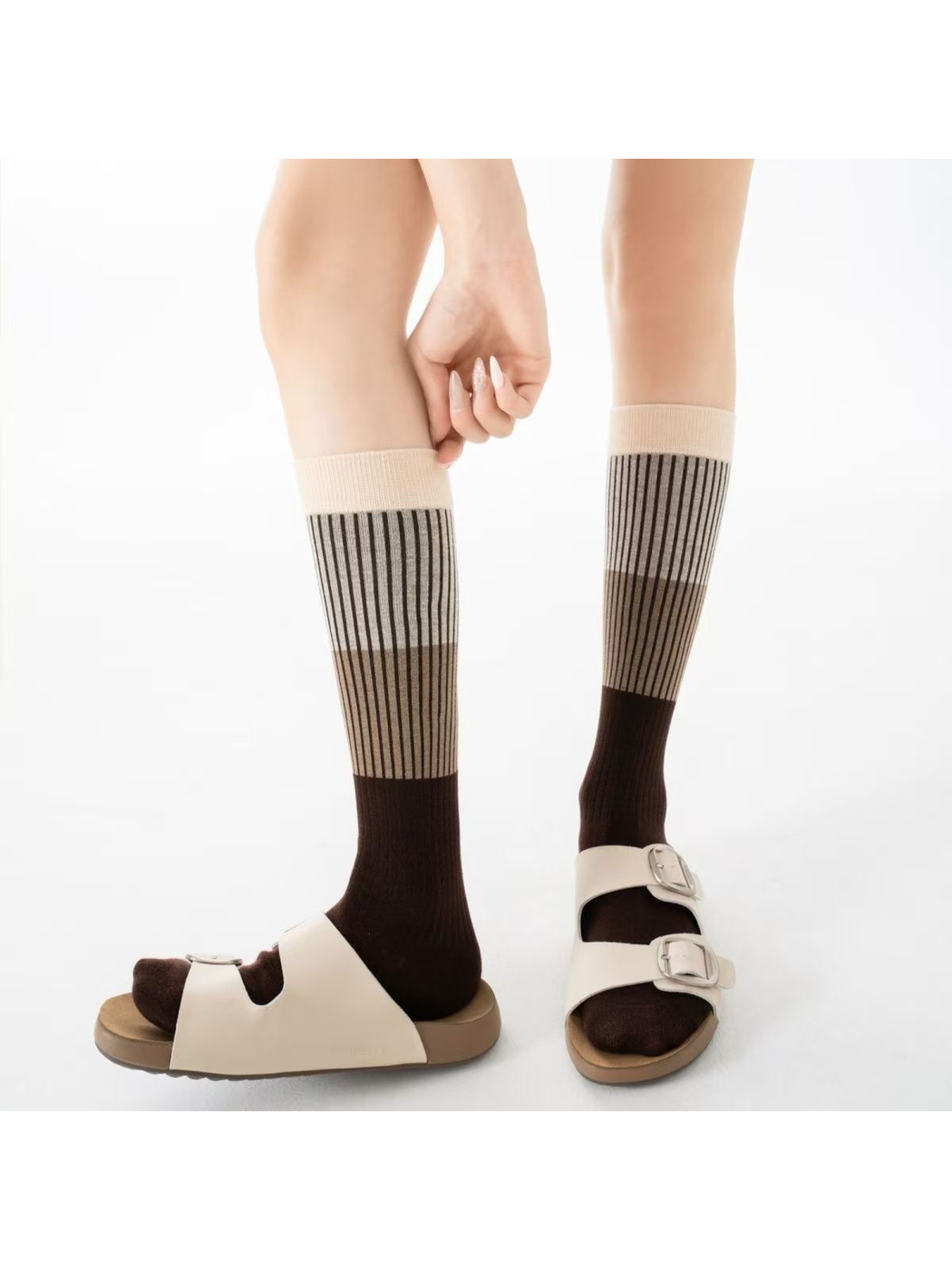 Beige Coffee knee-high striped socks worn with cream sandals