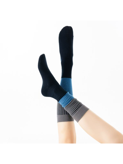 Close-up of ribbed Black Blue socks with striped color-block legs