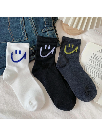 White, black and dark gray smiley crew socks displayed together