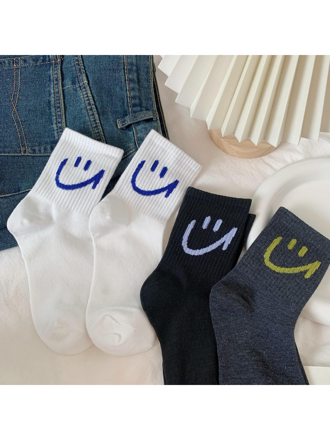 White, black and dark gray smiley crew socks arranged side by side