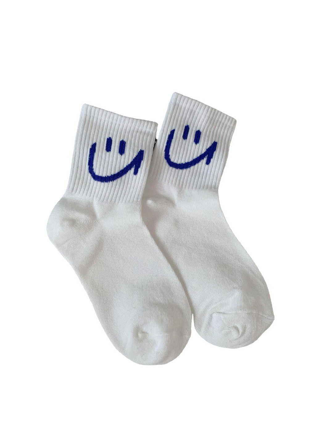 White crew socks with blue smiley motifs on a plain background