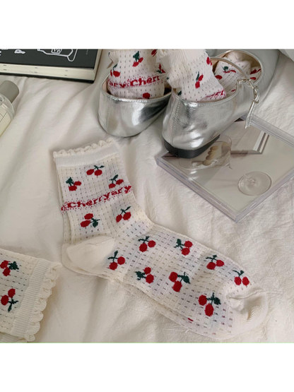 Ivory cherry-pattern crew sock with ruffled cuff and solid-knit toe and heel