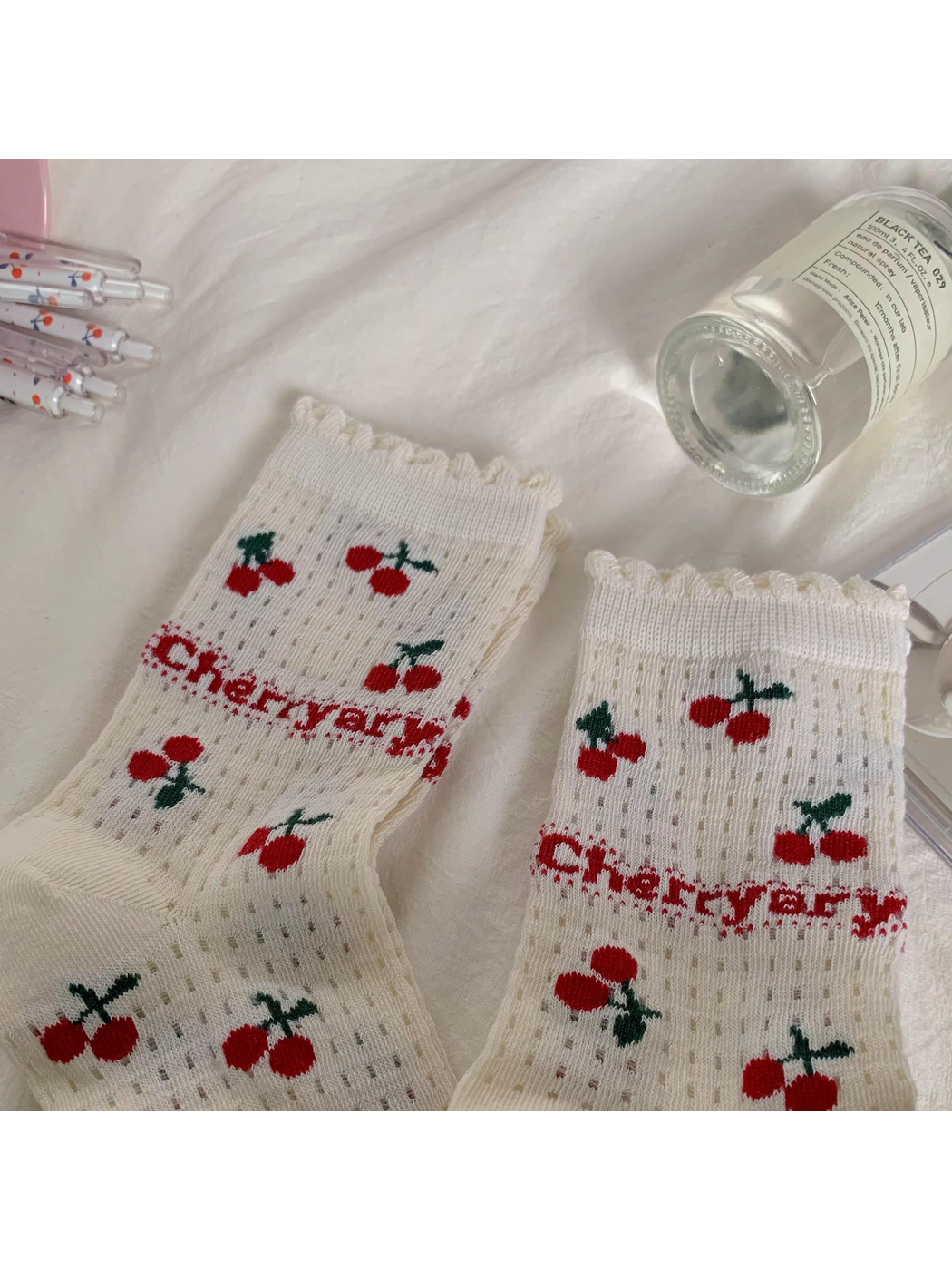 Ivory cherry-pattern socks with ruffled cuff edges