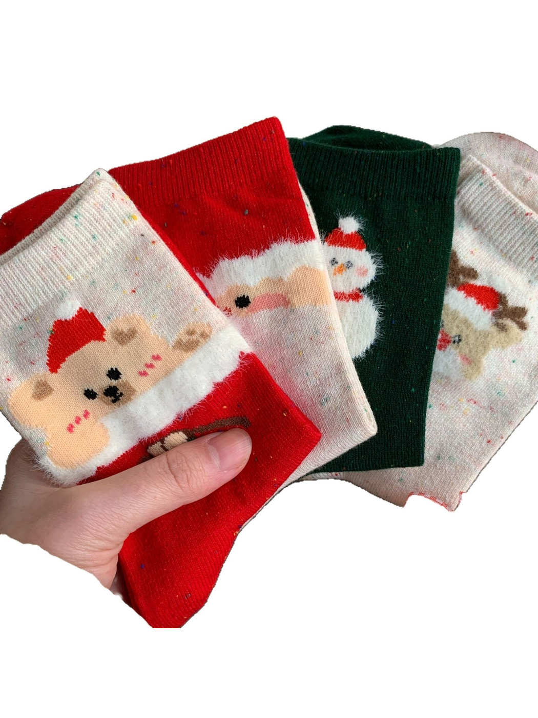Four holiday crew sock styles held against a white background