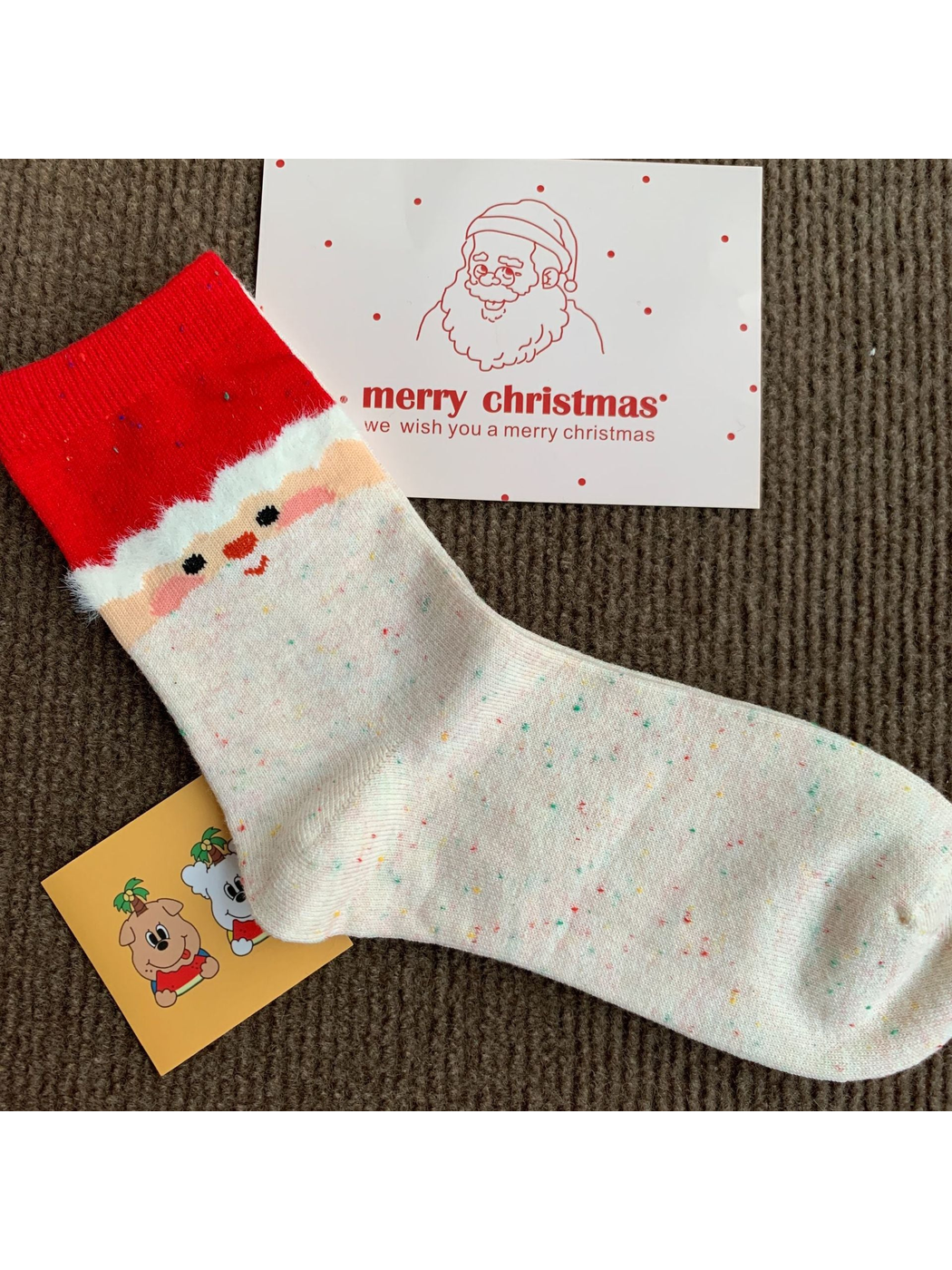 Santa cream crew sock with a red cuff and fuzzy white trim