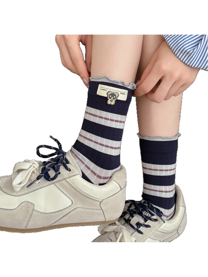 Navy striped crew socks styled with cream sneakers