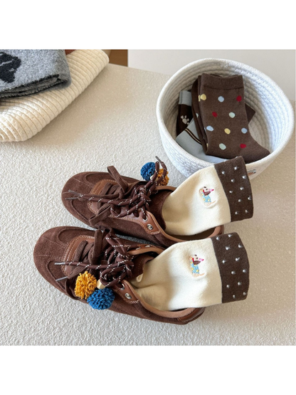 Ivory Dachshund socks styled with brown shoes and a basket of assorted sock styles