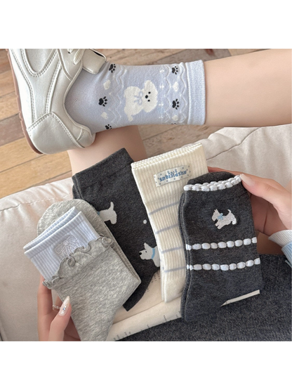 Assorted gray, ivory and light blue crew socks styled with silver shoes