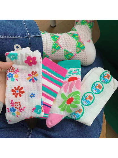 Assorted floral, striped, butterfly and medallion crew socks displayed together