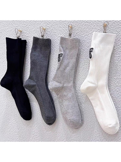 Black, Dark Gray, Light Gray and White ribbed crew socks displayed together